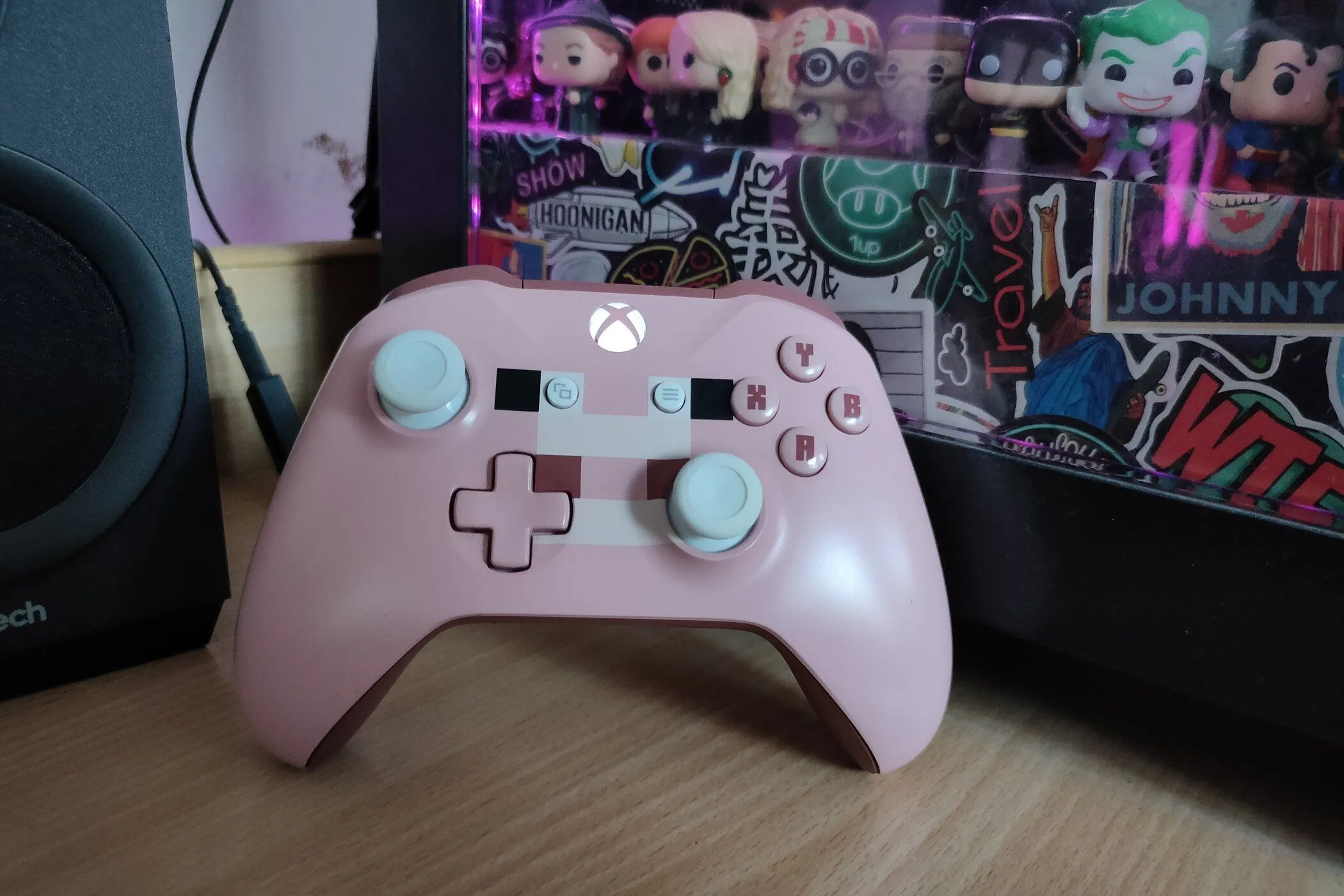 Un controlador Xbox One Minecraft Pig de edición especial apoyado sobre una computadora.